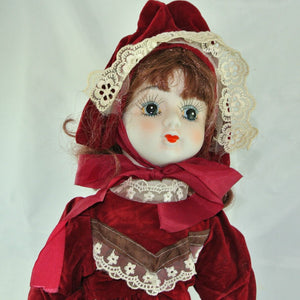 Puppe mit Rotem Kleid / Porzellankopf & Stoffkörper / ca. 47 cm